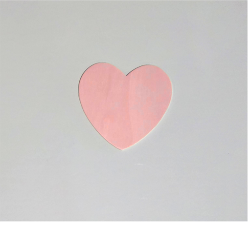 Pink heart cutout on a light gray background.
