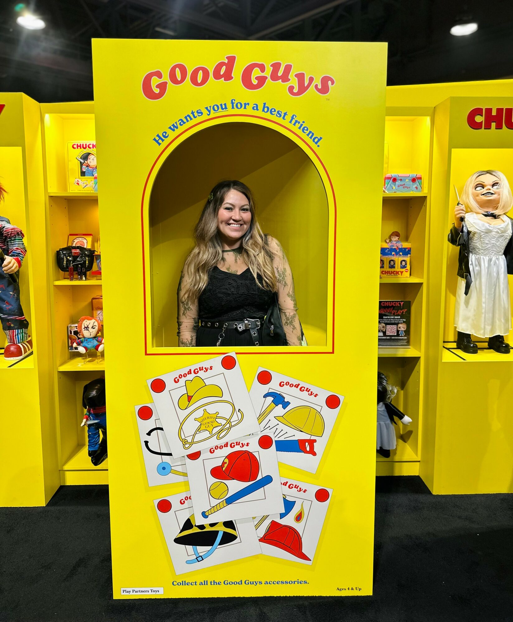 Young woman with long hair smiling inside a yellow display with cards and the text 
