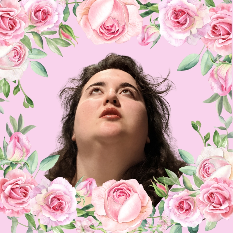 Young woman with dark hair looking upward, surrounded by pink roses and green leaves on a pink background.