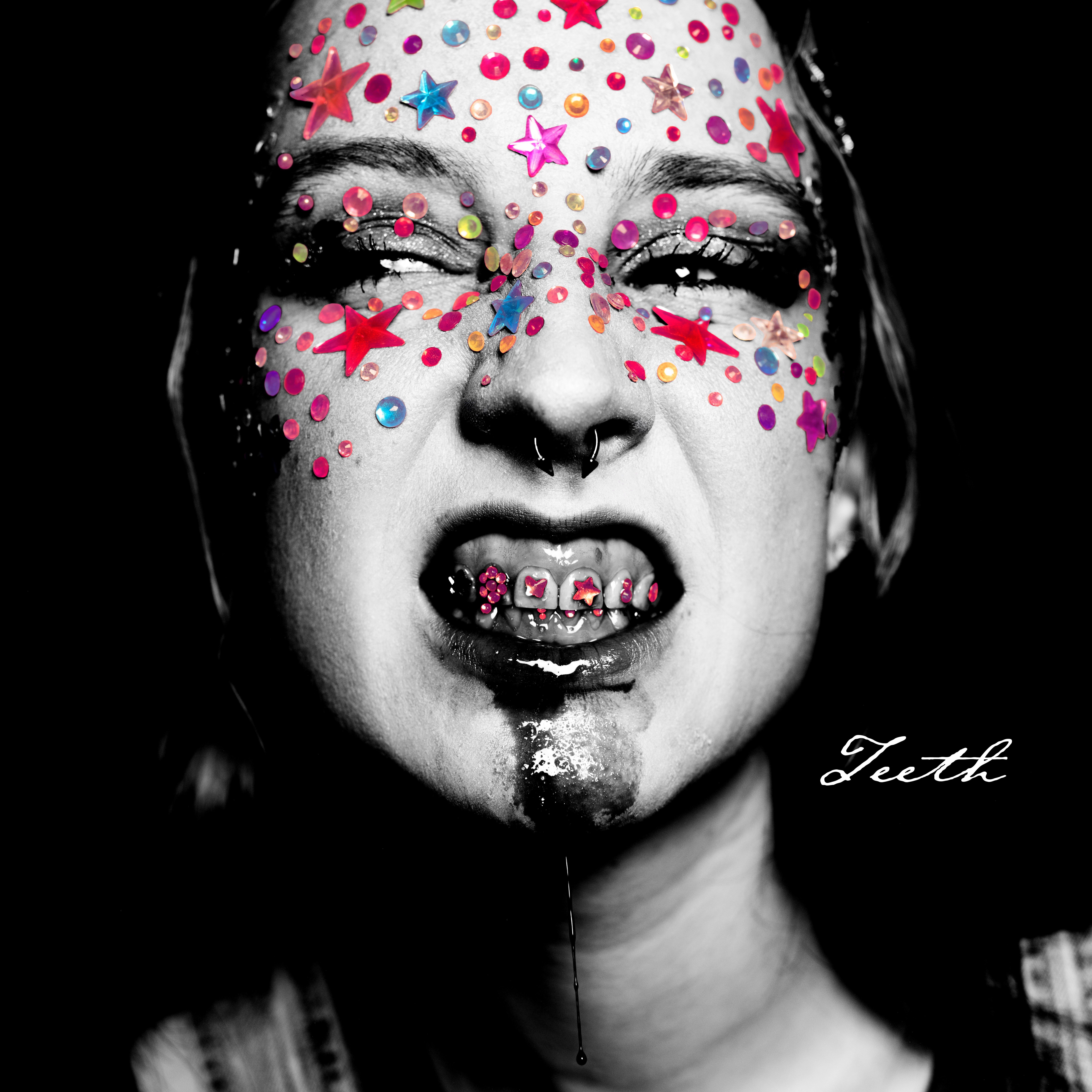 Close-up of a person's face with colorful star and dot decorations, eyes closed, tongue out, and a signature in the bottom right.