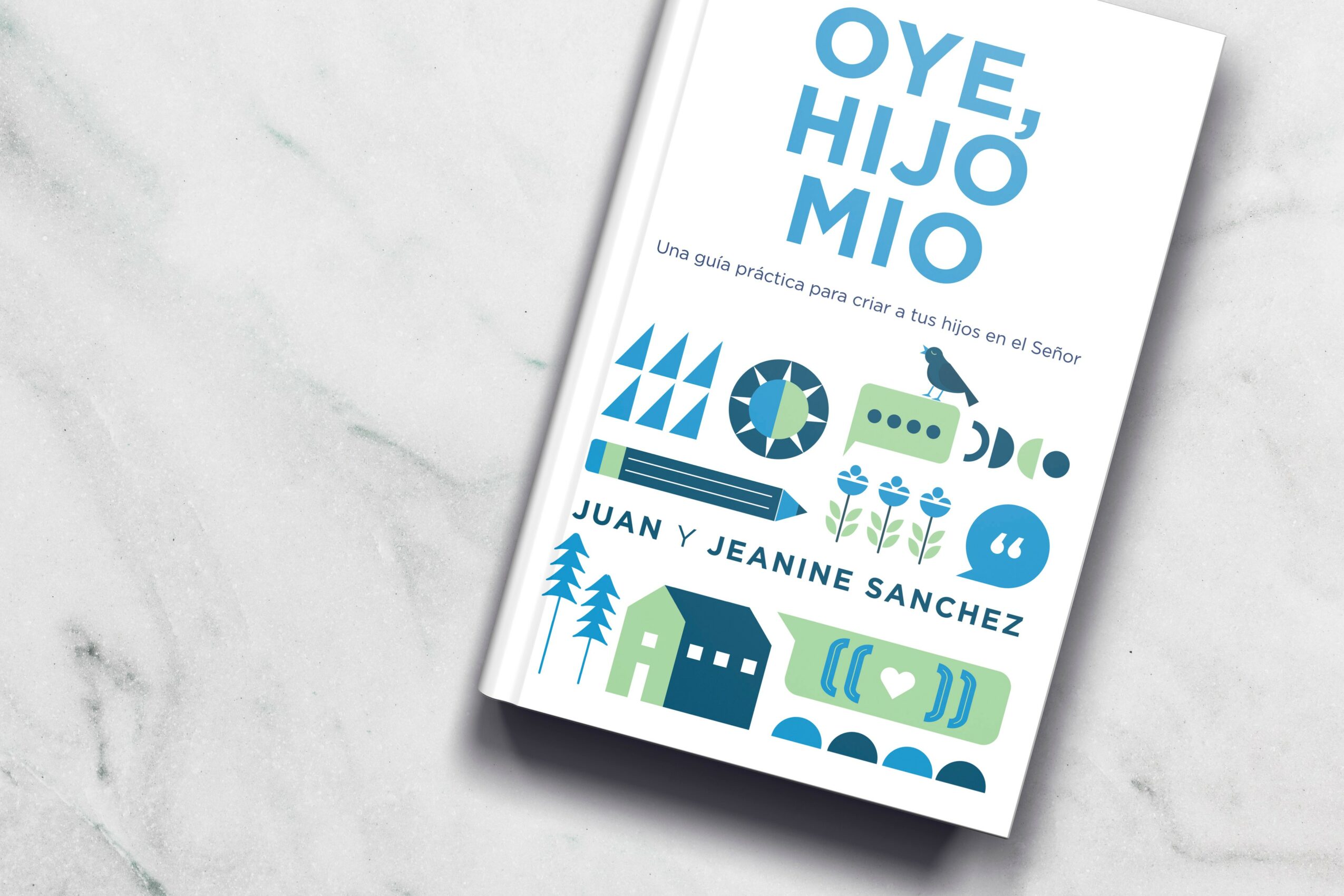 Book cover with blue and green illustrations of trees, houses, and abstract shapes, titled 'Oye, Hijo Mío' by Juan y Jeanine Sanchez.