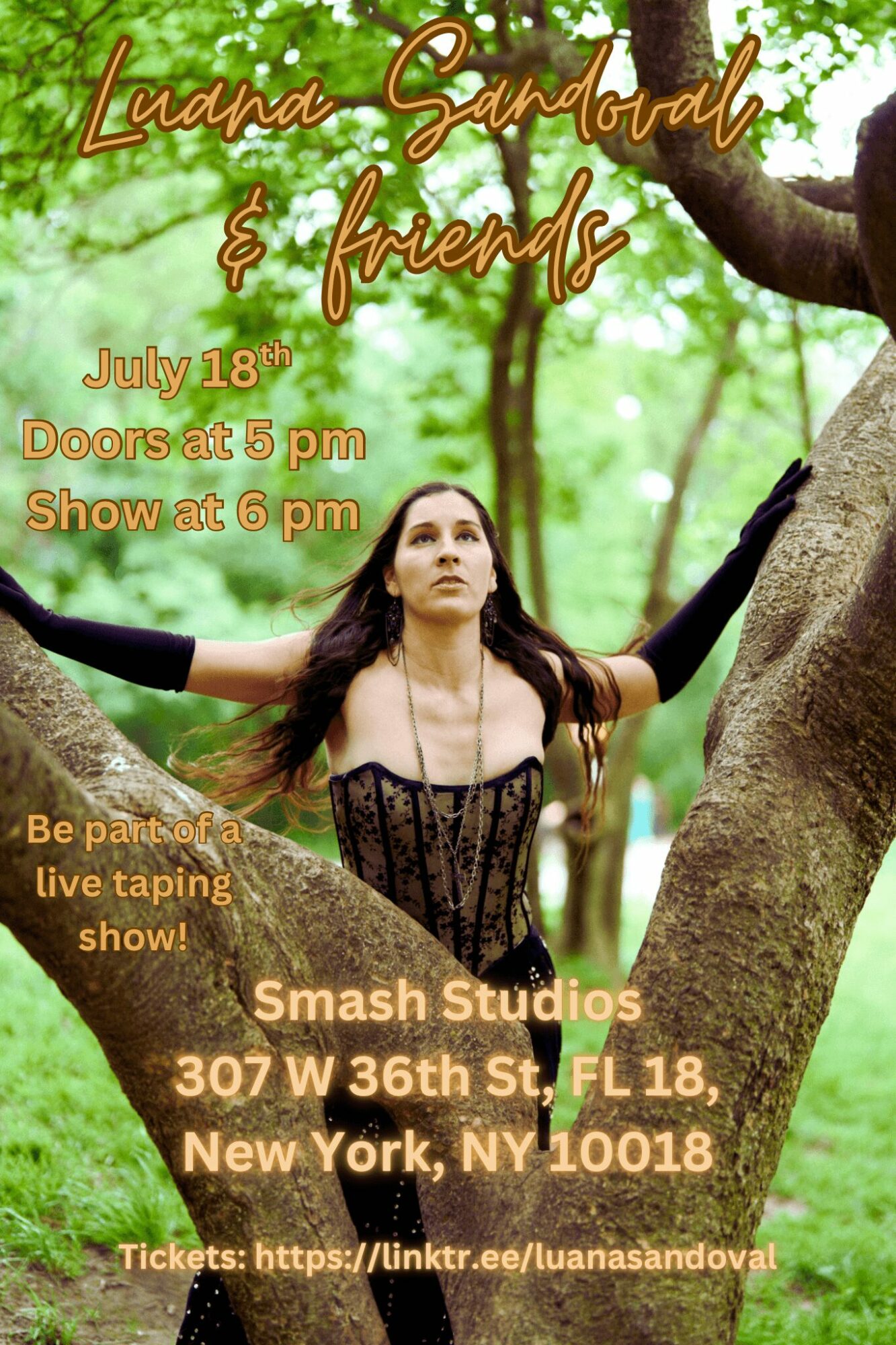 Woman in a forest with arms outstretched, wearing a black dress, surrounded by green trees and sunlight.