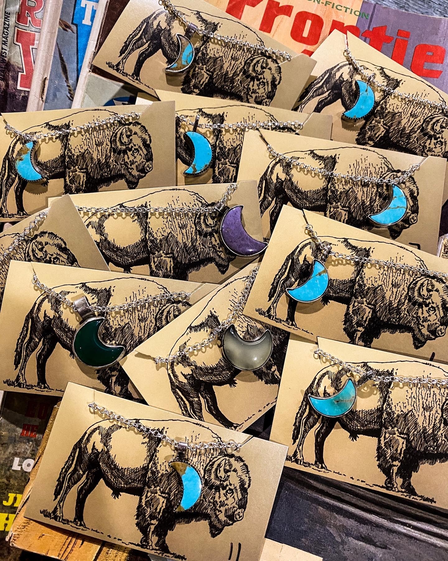 Multiple cards featuring a sketch of a bison with colorful, curved shapes on their necks, arranged overlapping each other.