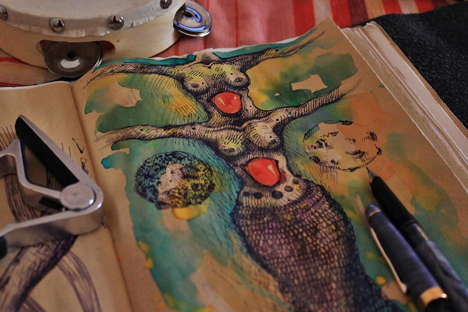 Colorful watercolor painting of a creature with multiple limbs and red eyes on an open sketchbook page.