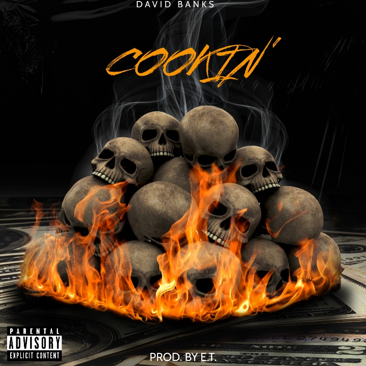 Stacked skulls with fire and smoke, with text 'Cookin'' and 'David Banks' at top, on a dark background.