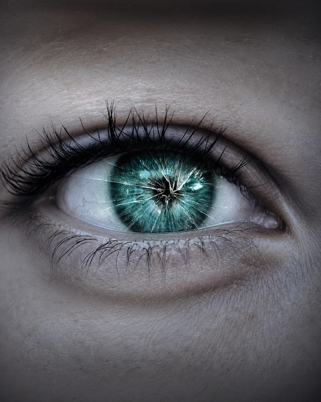 Close-up of a human eye with a vibrant blue-green iris and detailed reflections, surrounded by eyelashes and skin.