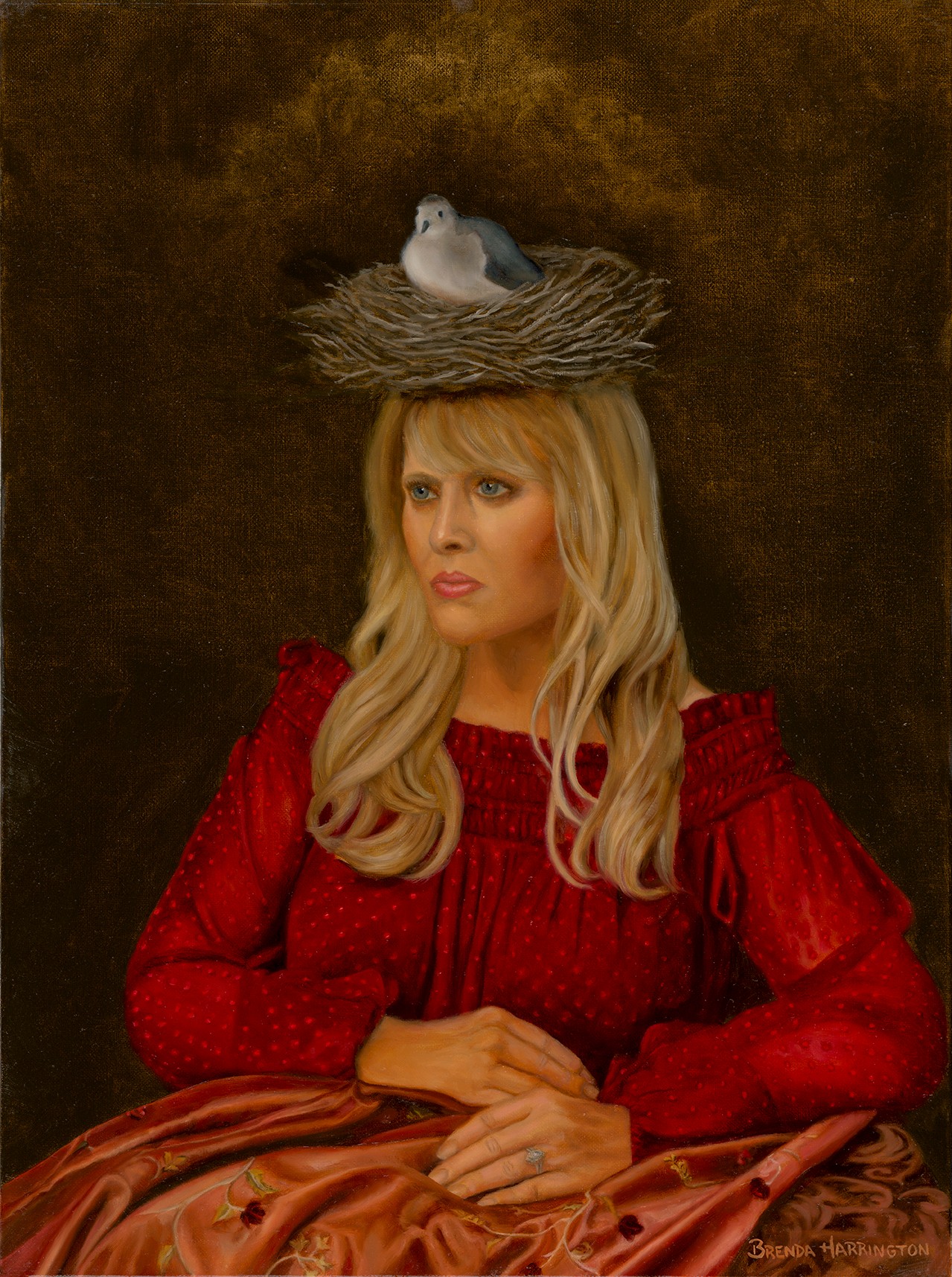 Woman with long blonde hair wearing a red dress, sitting with hands folded, bird in nest on her head, dark background.