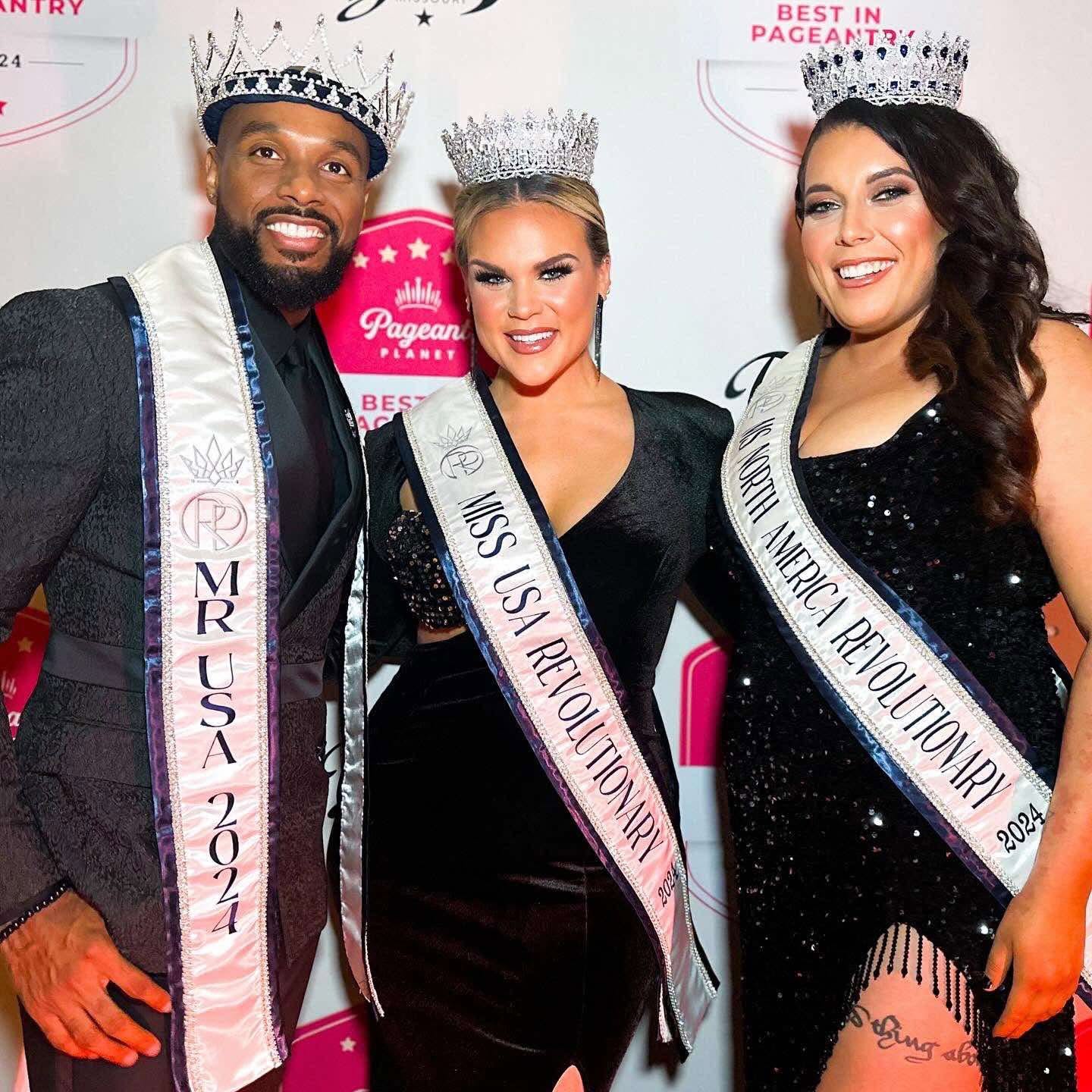 Three people wearing crowns and sashes, smiling at a pageant event, with a pink and white backdrop.