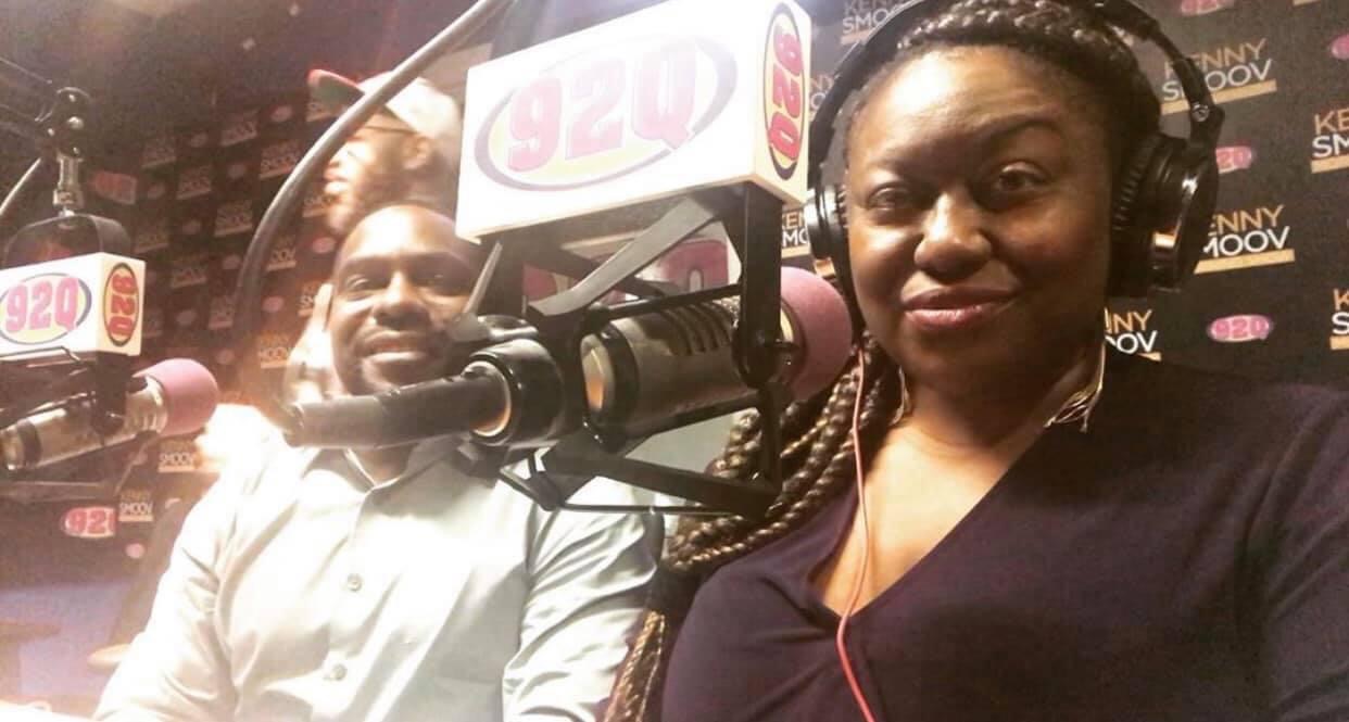Two people in a radio studio with microphones and headphones, smiling at the camera.