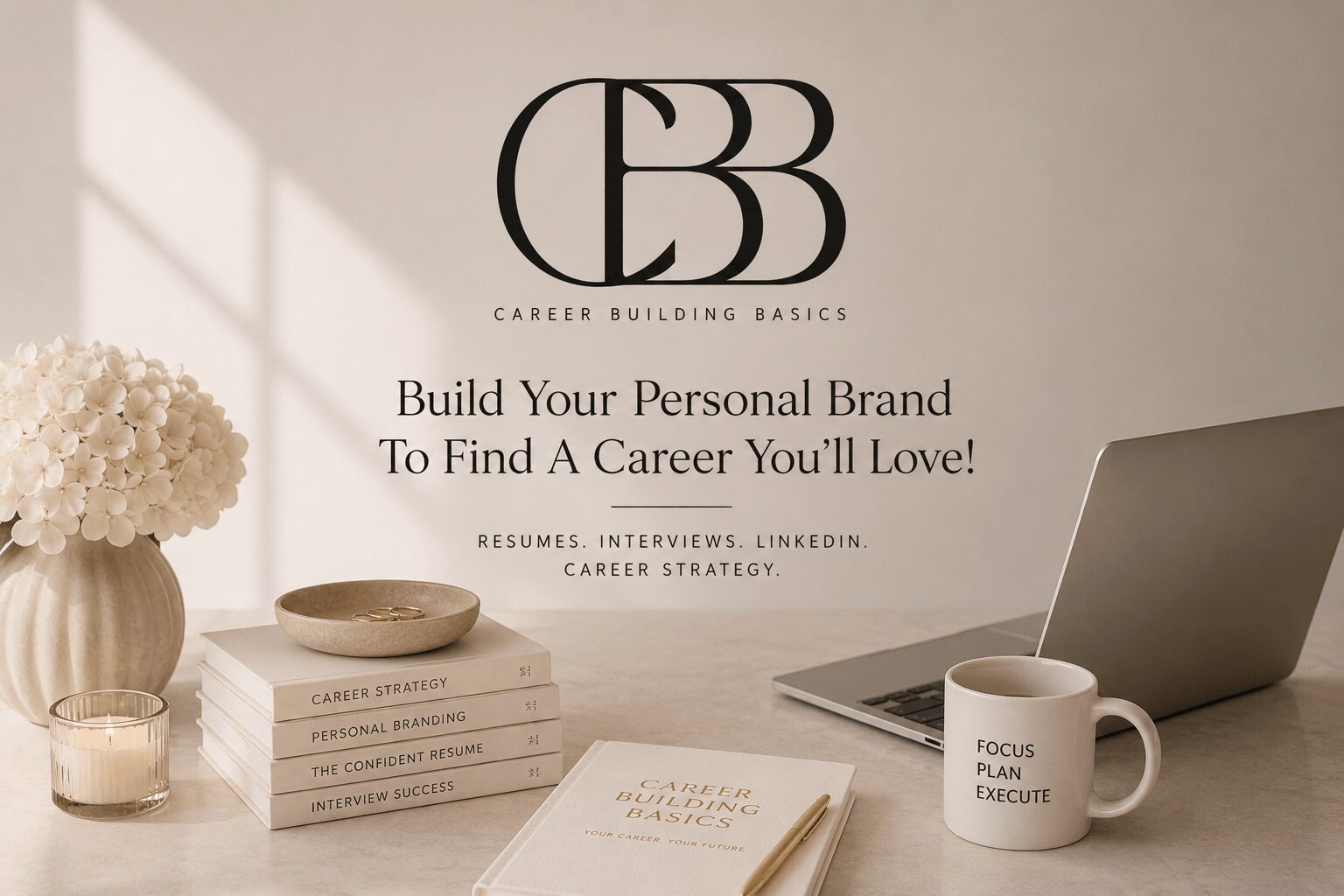 Open laptop, stack of books, mug, and flowers on a desk with a motivational career message on the wall.