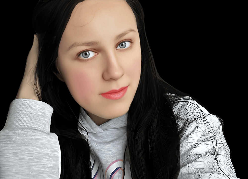 Young woman with long black hair and blue eyes, wearing a gray hoodie, looking at the camera against a black background.