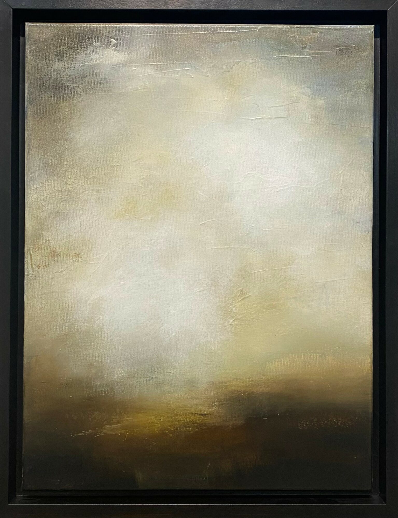 Abstract painting with light and dark shades of beige, cream, and brown, framed in black.