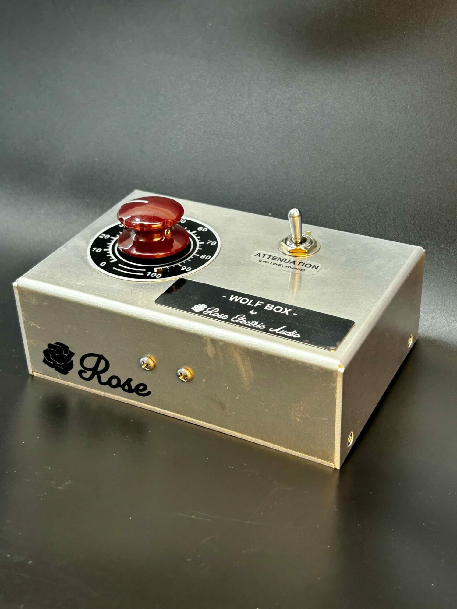 A metallic box with a red knob, black dial, and a small switch, labeled 'Bakel' and 'The Black Box'.