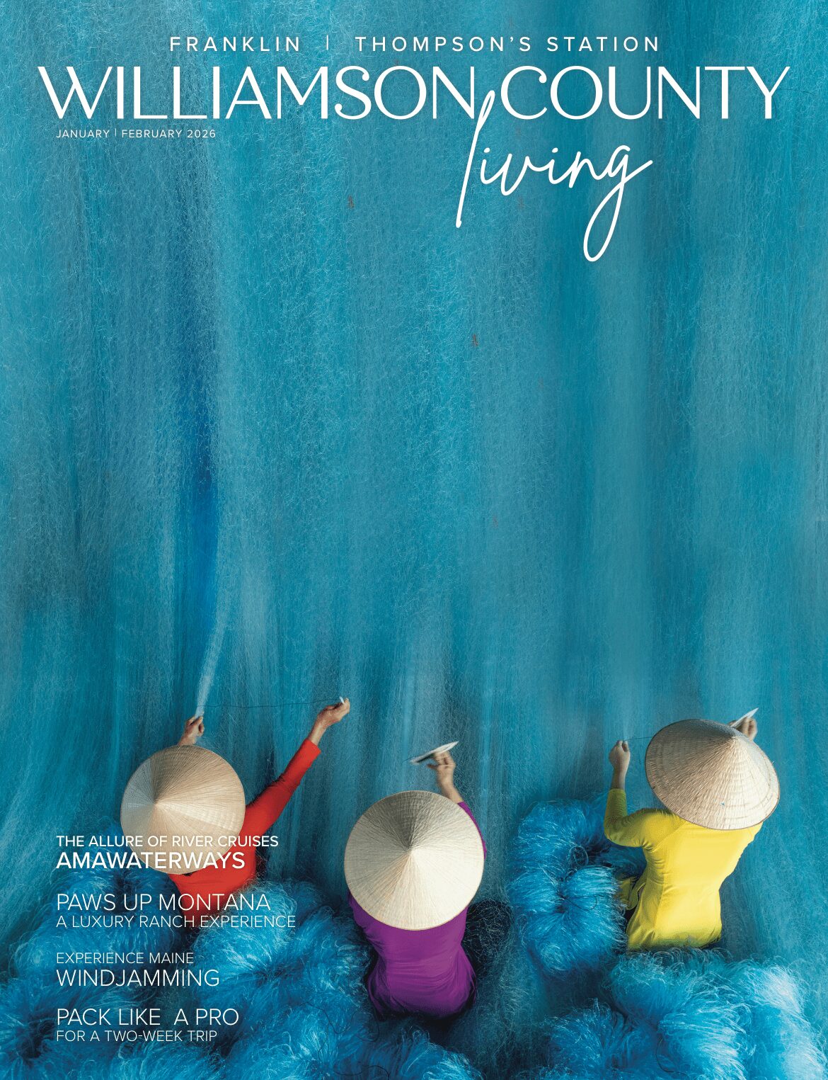 Magazine cover with blue background, white text, and three people with umbrellas, one in purple, one in yellow, and one in white.
