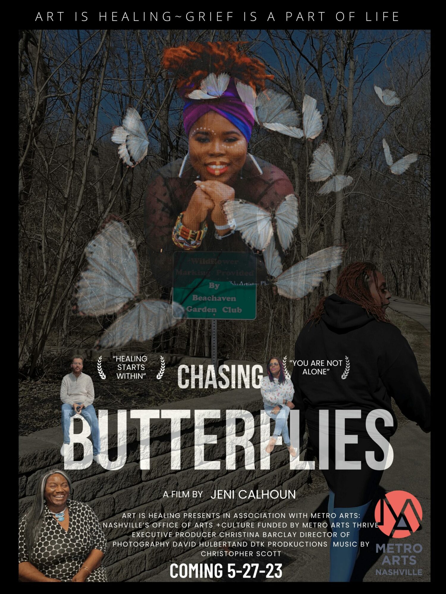 Smiling woman with colorful headwrap surrounded by white butterflies outdoors, with text about grief and healing, and a green sign.