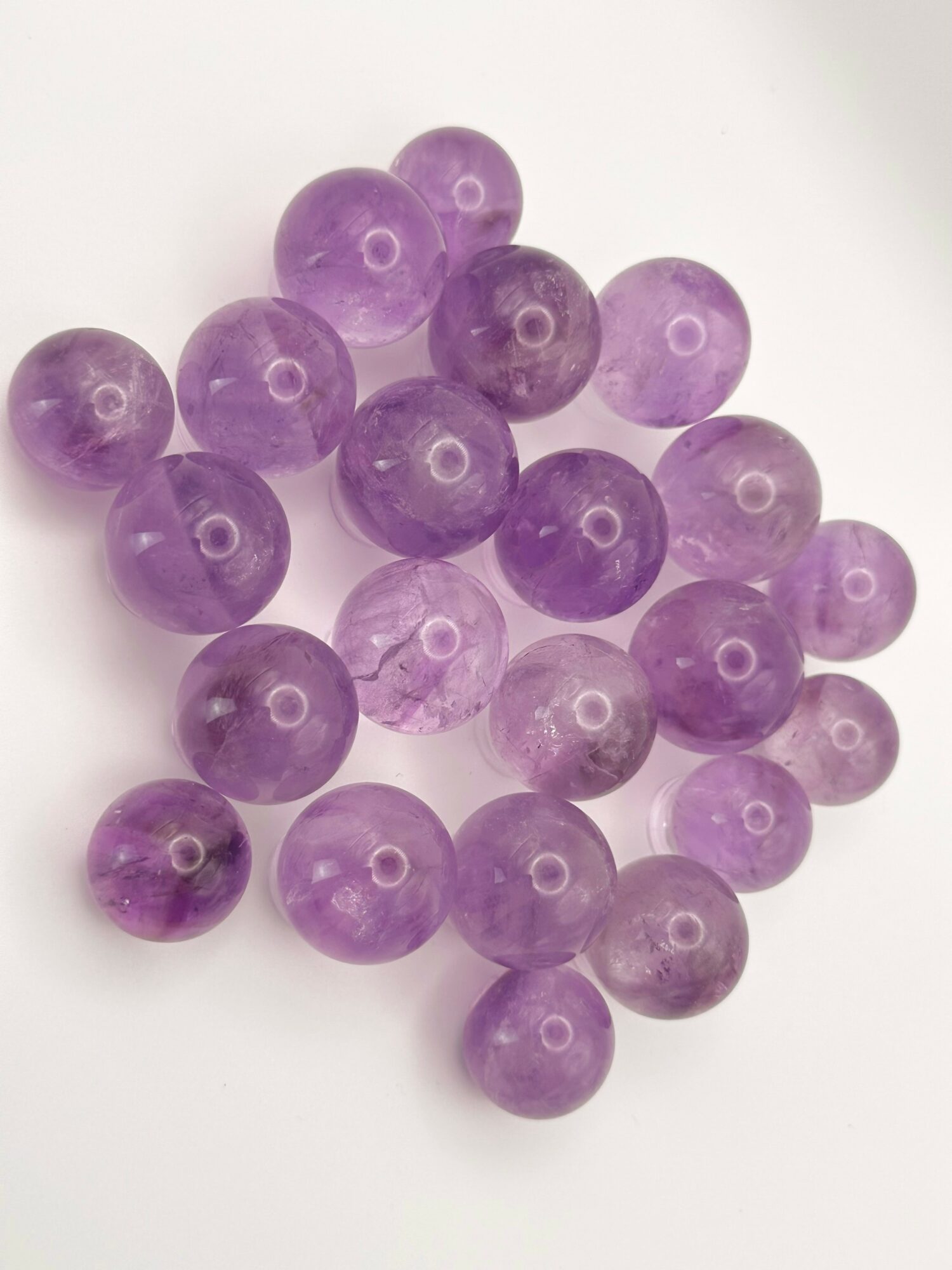 Group of purple round beads on a white background.