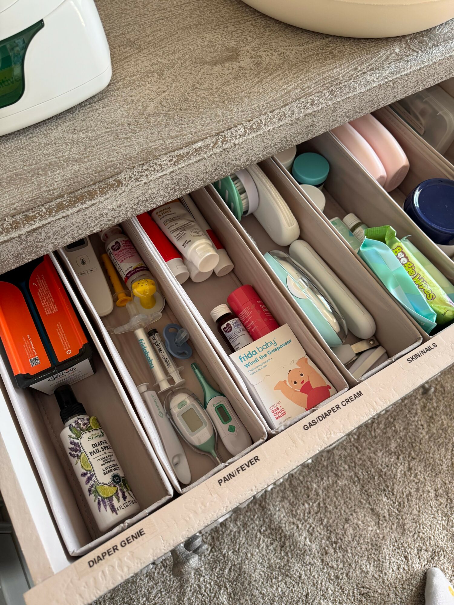 Open drawer with organized compartments containing various medical supplies and devices.