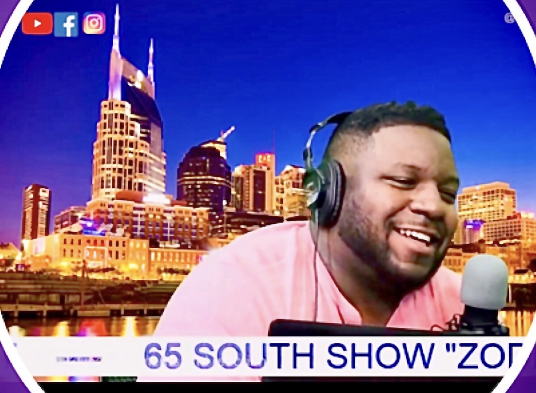 Man with headphones smiling in front of a city skyline at night, with social media icons in the top left corner.