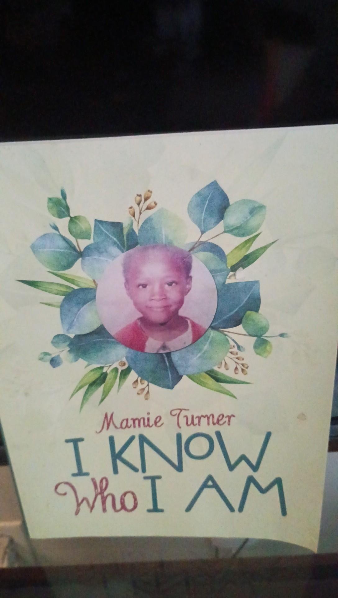 Child's portrait surrounded by leaves and flowers, with handwritten text about identity and self-awareness.