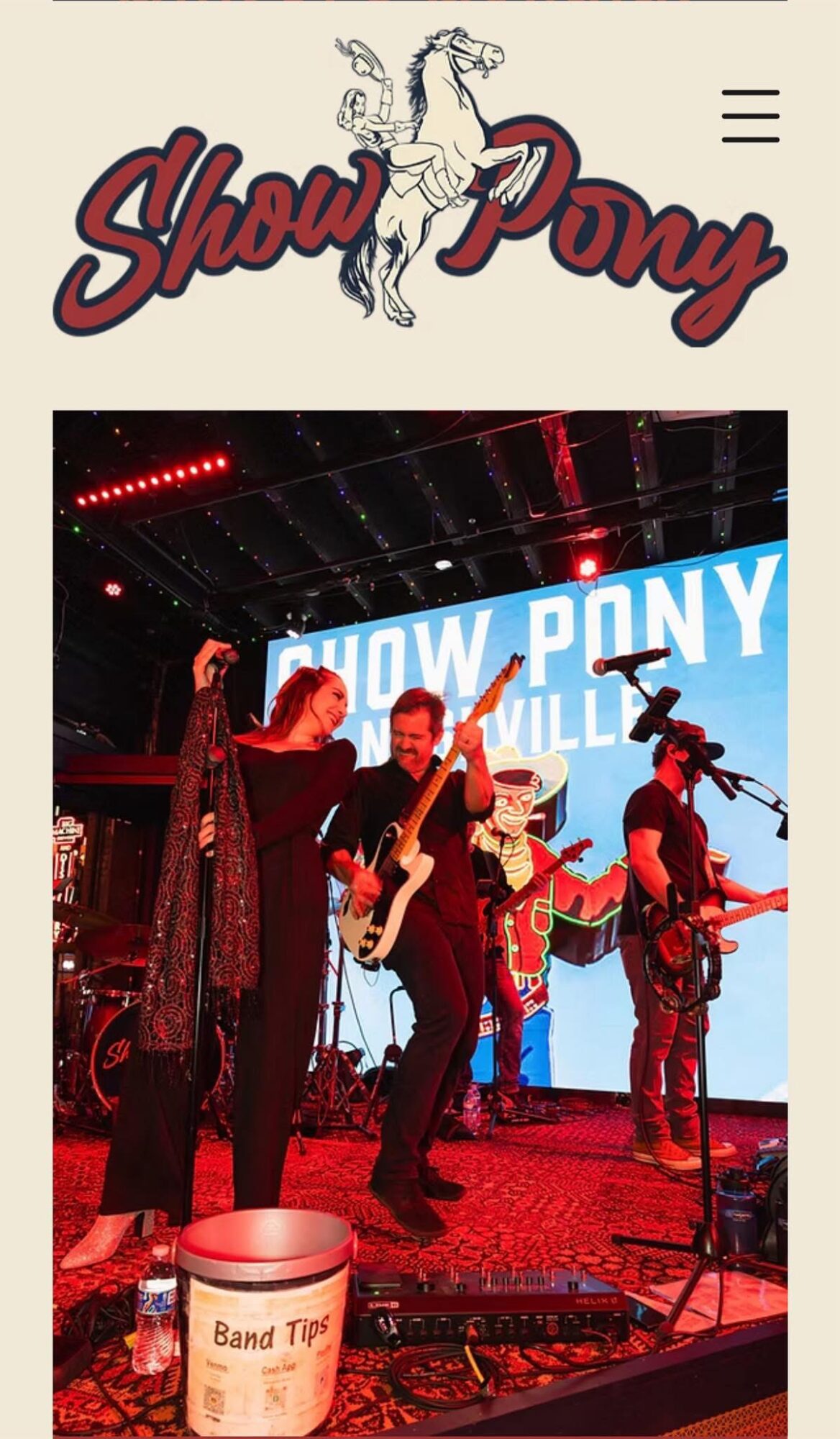 Band performing on stage with a large screen behind them displaying 'Show Pony' and 'Will' in blue text.