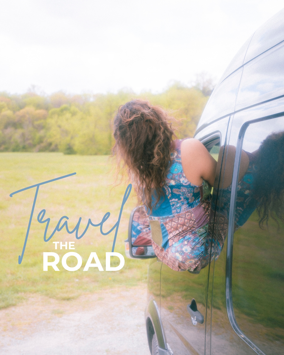 Person with curly hair sitting on a vehicle's window, outdoors with trees and grass, text reads 'Travel the Road'.
