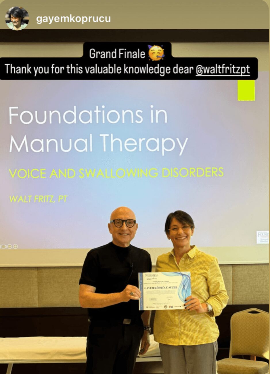 Two people holding a certificate in front of a presentation slide about manual therapy foundations, voice, and swallowing disorders.