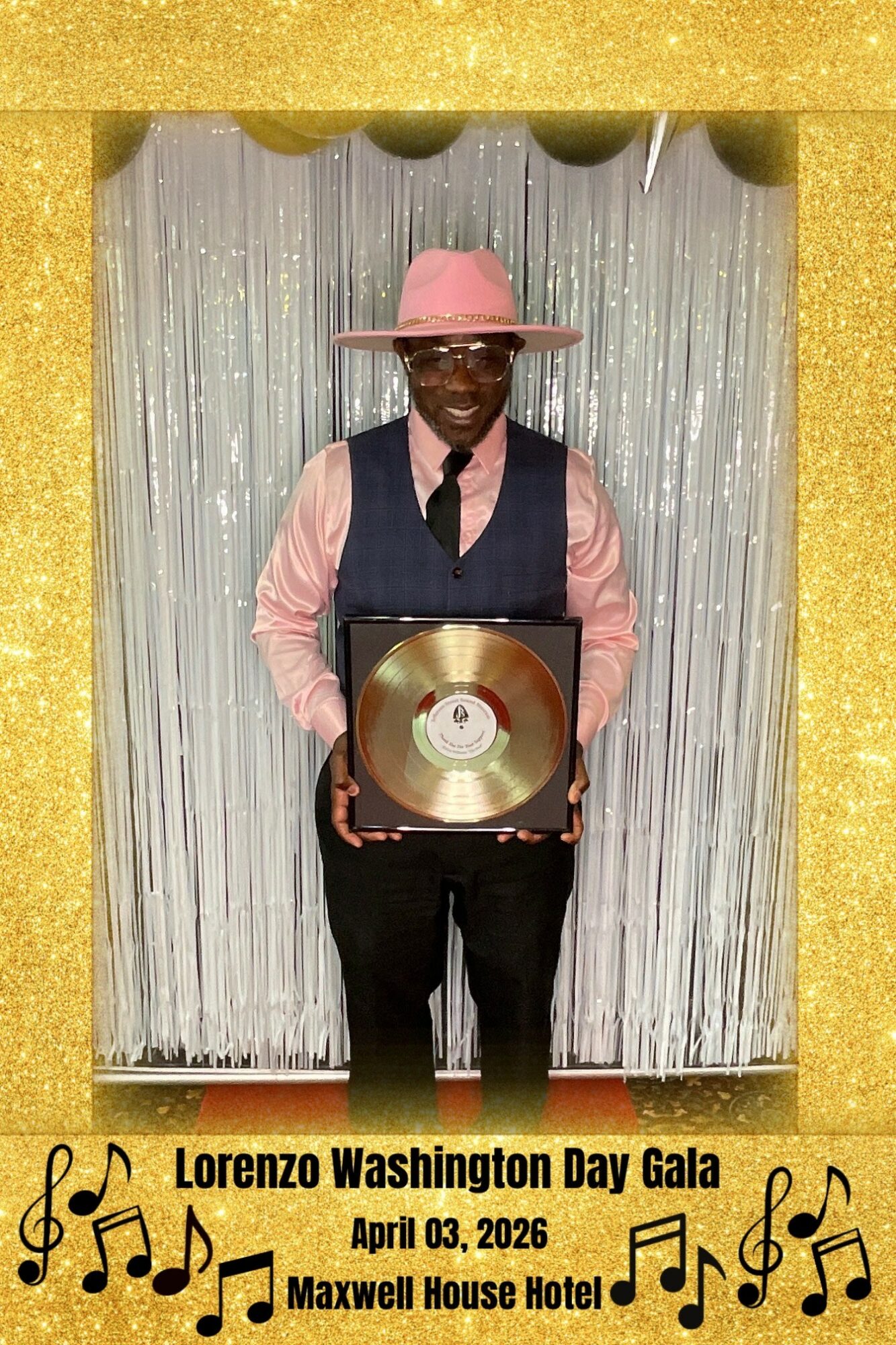 Man in pink hat and shirt holding a gold record award, standing in front of silver curtain, gold border frame, event details below.