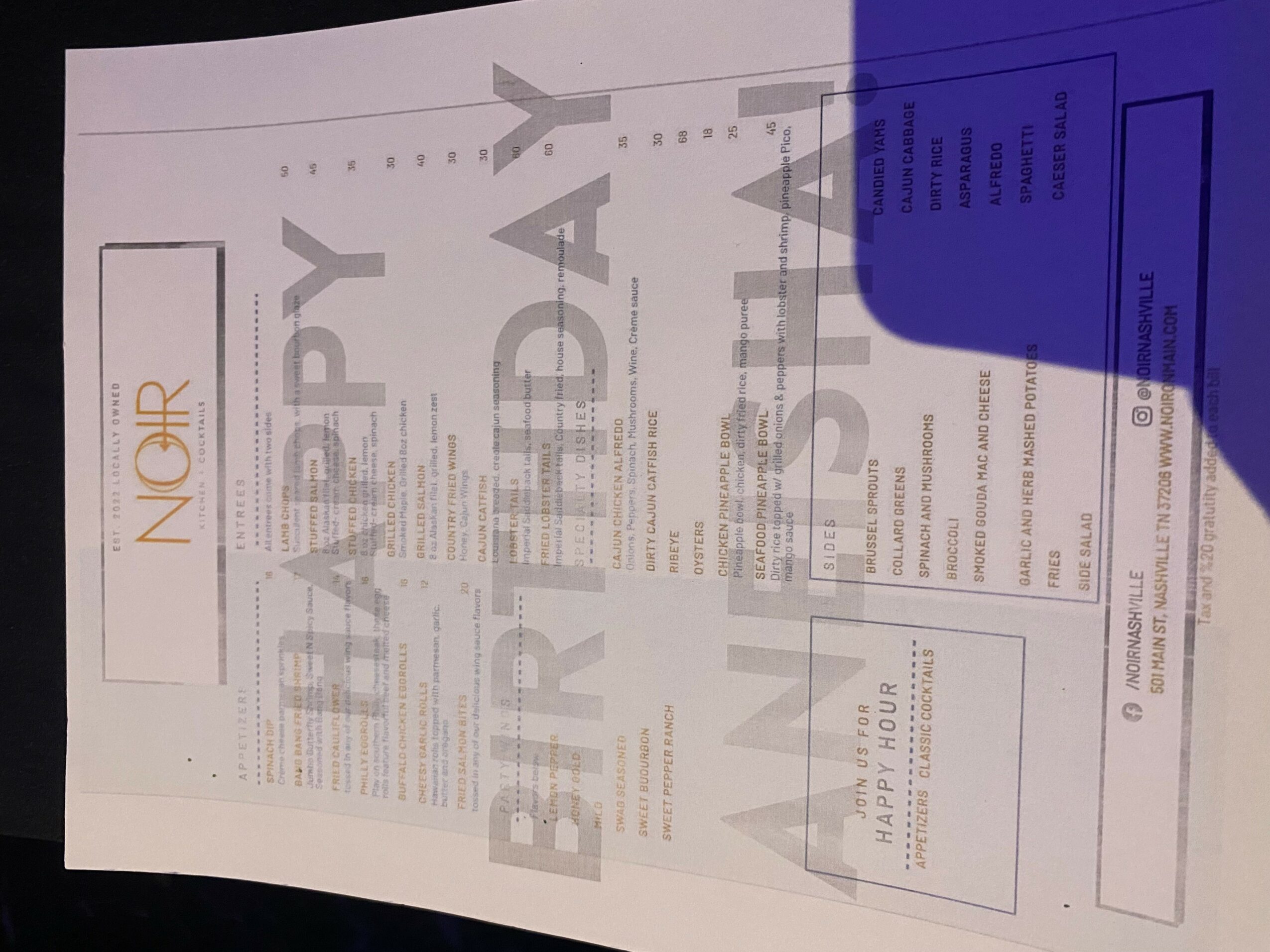 A printed document with text and graphics, partially covered by a blue object in the top right corner.