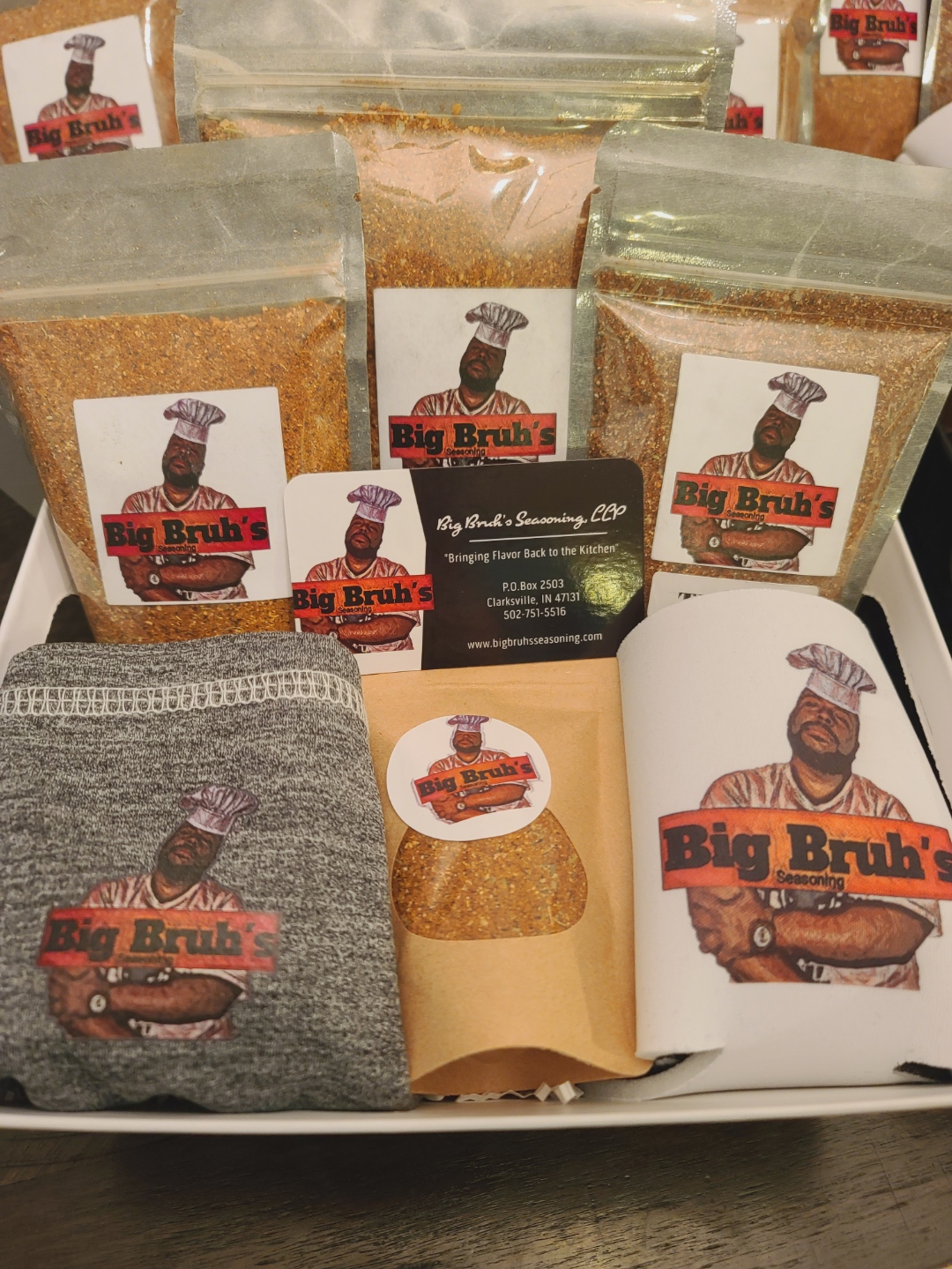 Assorted spice or seasoning packages with a logo of a man in a chef's hat, displayed on a tray.