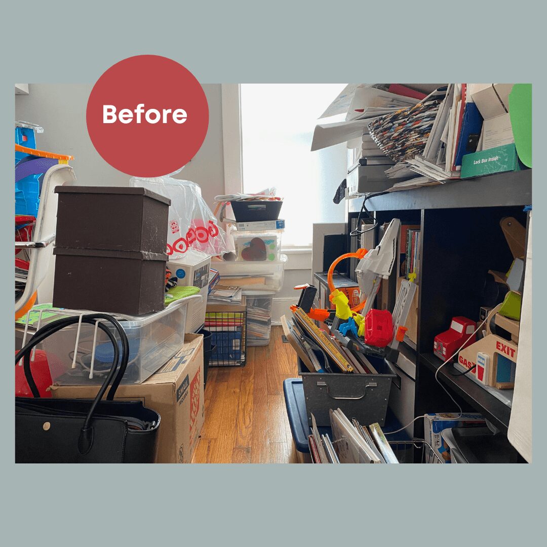 Cluttered room with shelves, boxes, and books, viewed from the side, with a window in the background.