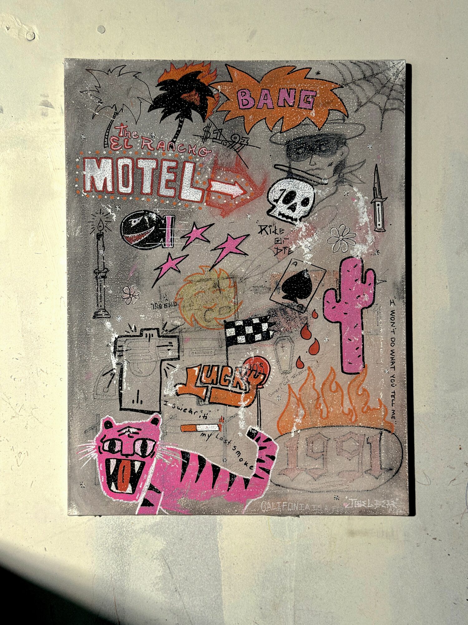 A collage of various stickers and drawings on a wall, including a skull, pink tiger, cactus, and text elements.