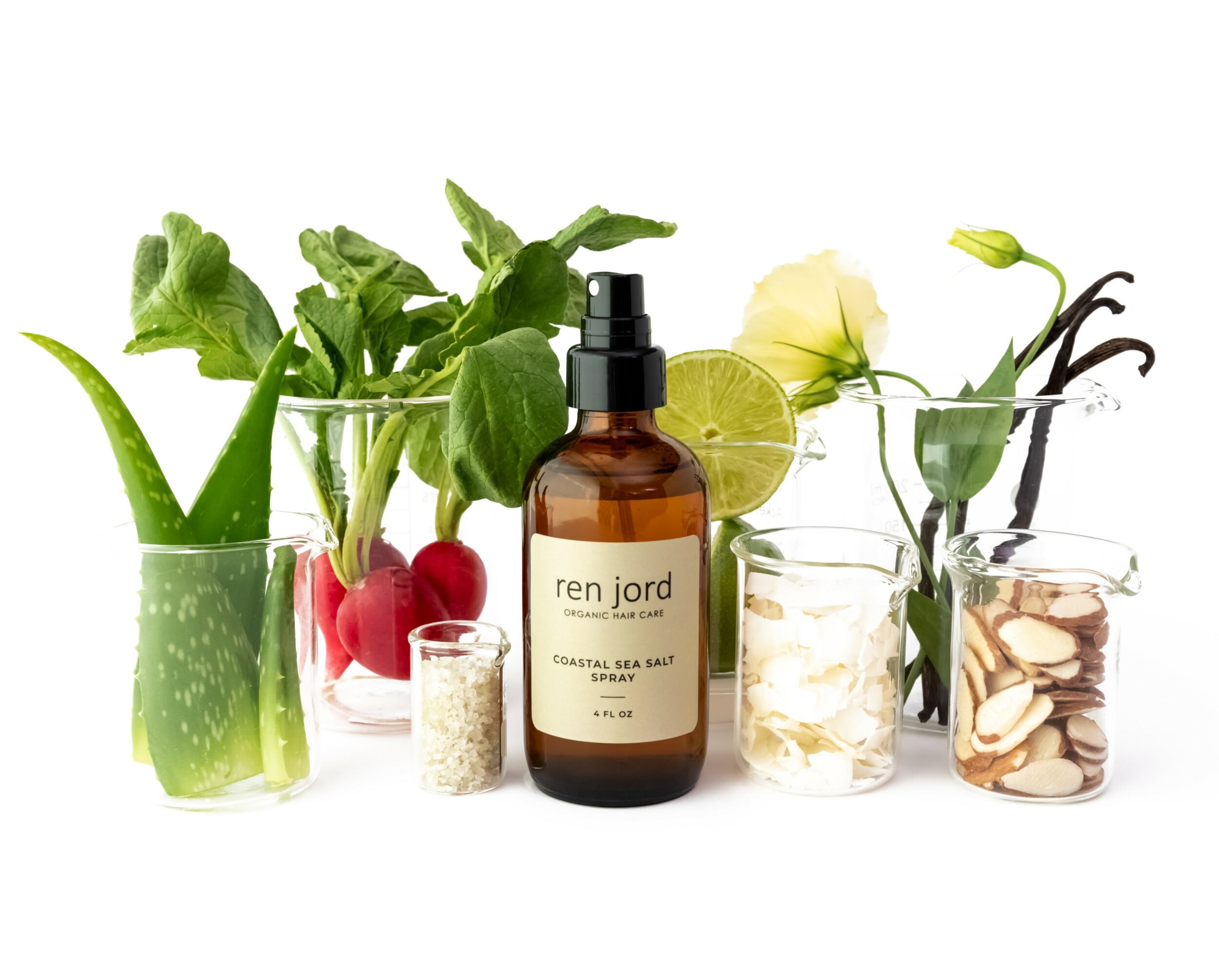 Arrangement of plants, herbs, and skincare products with a bottle labeled 'ren jord' among jars and flowers.