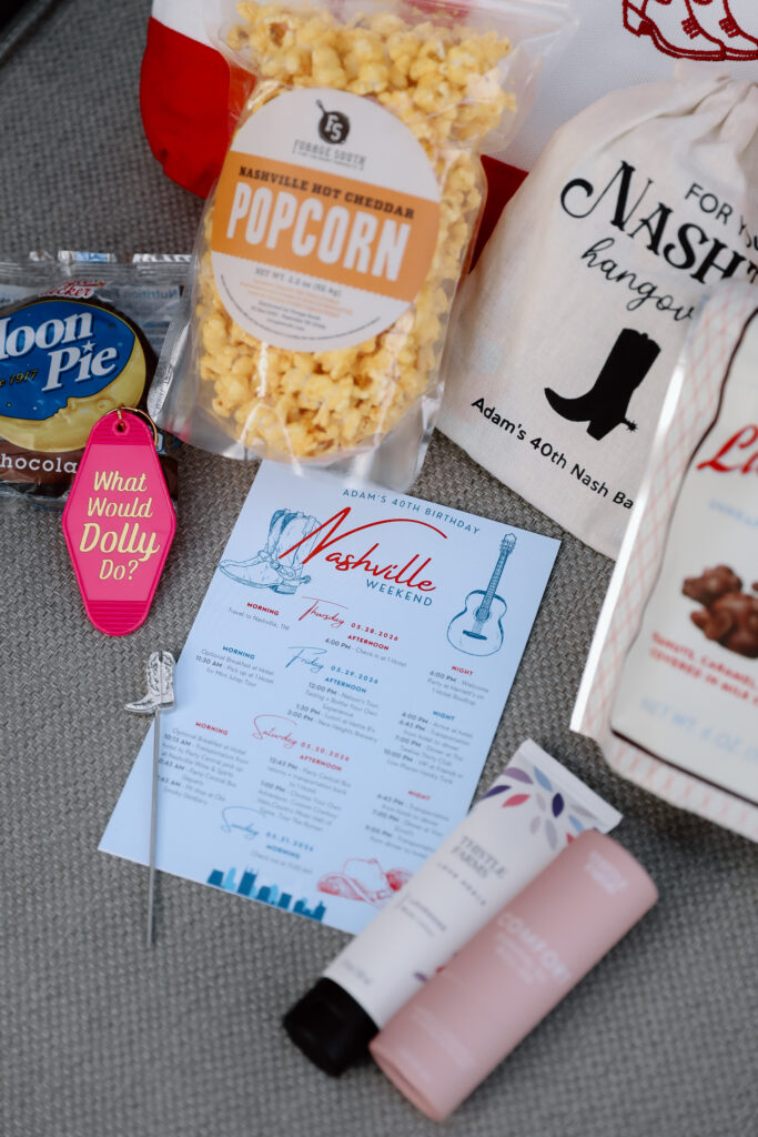 Popcorn bag, blue menu, pink lipstick, and other items on gray surface.