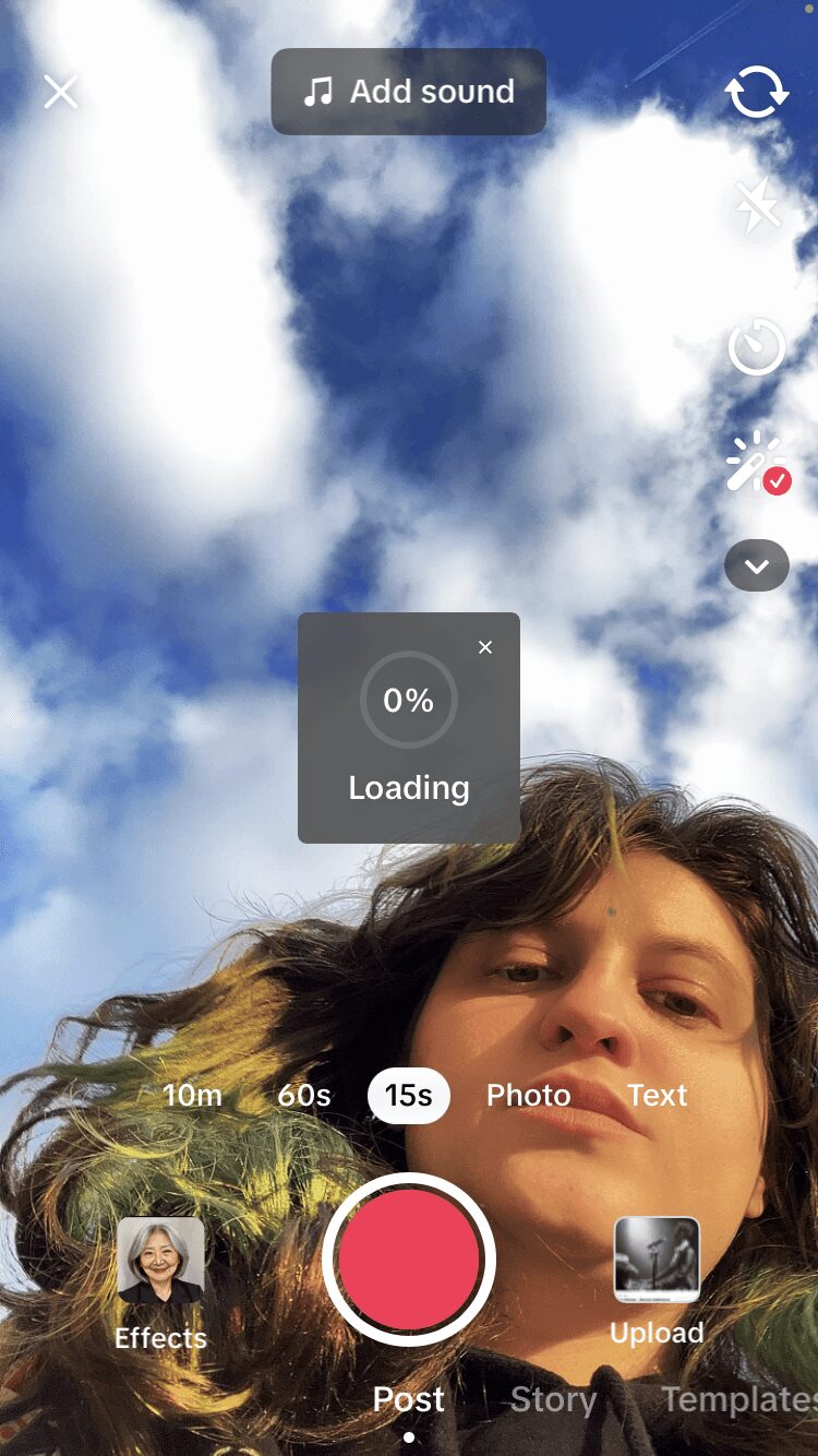 Partially visible person's face with hair, sky with clouds in background, app interface elements overlayed.