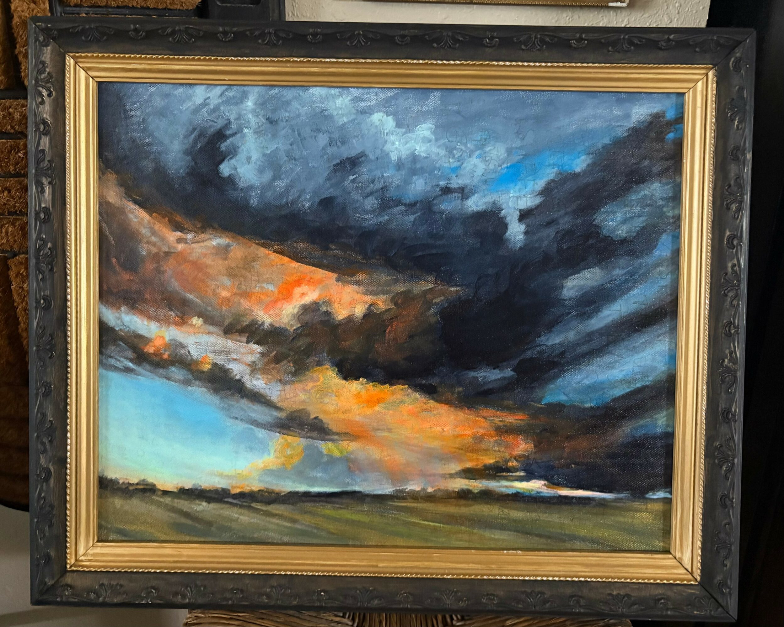 Landscape painting of a dramatic sky with dark clouds and a hint of sunset colors, above a flat horizon.