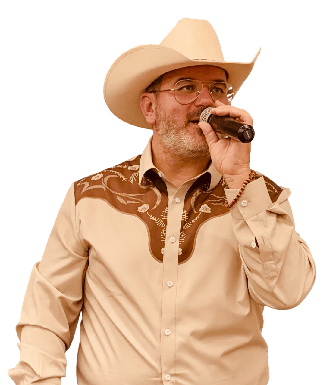 Man wearing cowboy hat and glasses, speaking into a microphone, against a black background.