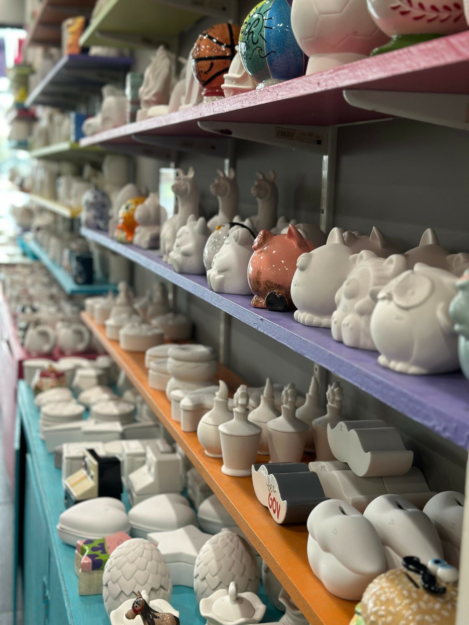 Shelves filled with various ceramic animal and decorative objects in a store.