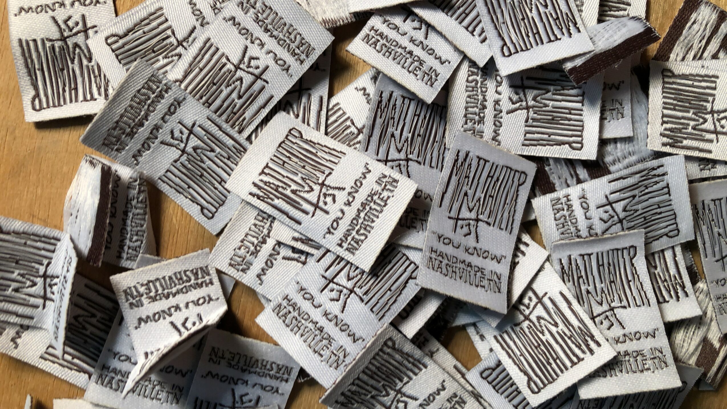 Numerous torn pieces of paper with printed text scattered on a surface.