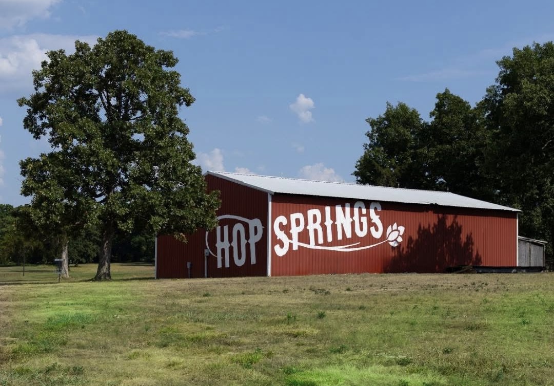 Red barn with white text reading