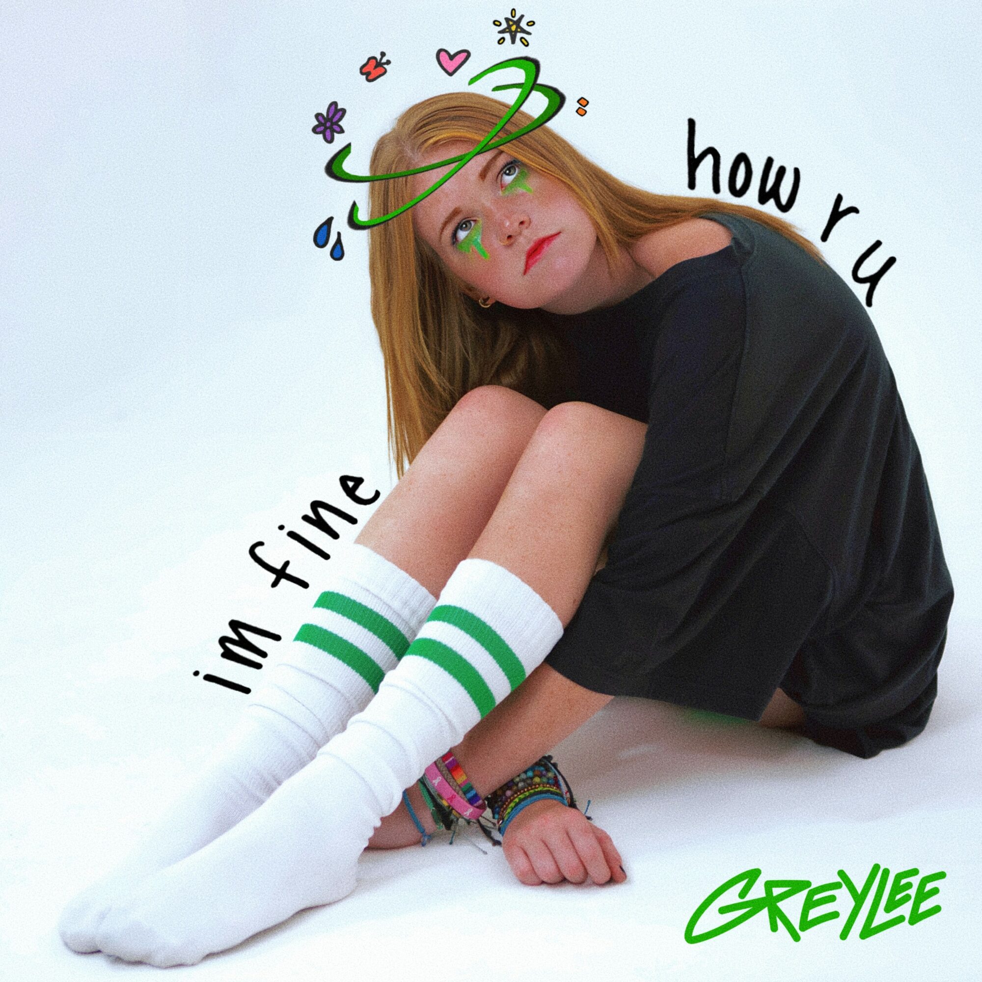 Young woman with long hair sitting on the floor, wearing a black dress and white knee-high socks with green stripes, looking upward. Colorful doodles and text surround her.
