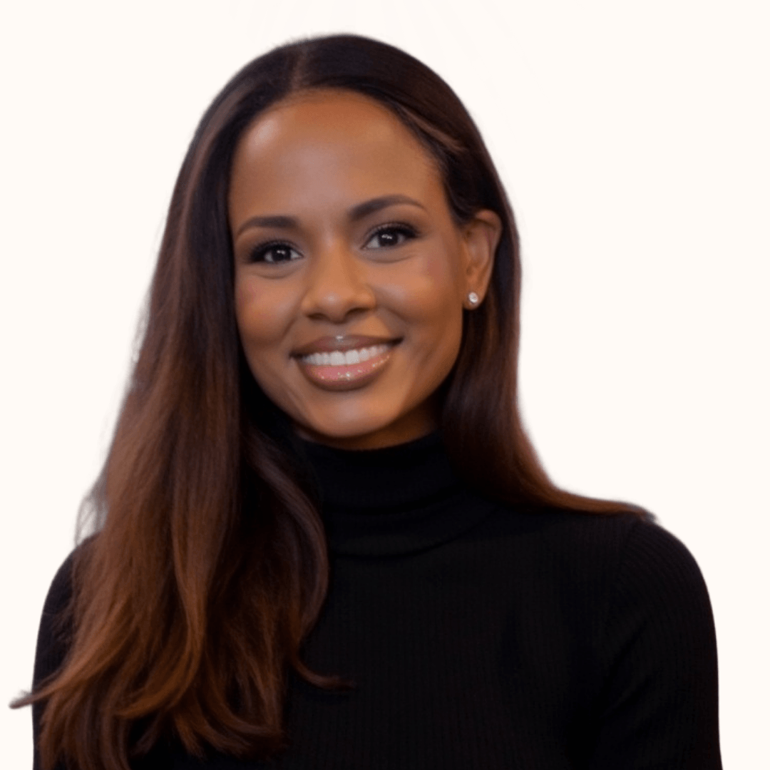 Portrait of a smiling woman with long brown hair wearing a black turtleneck, against a plain white background.