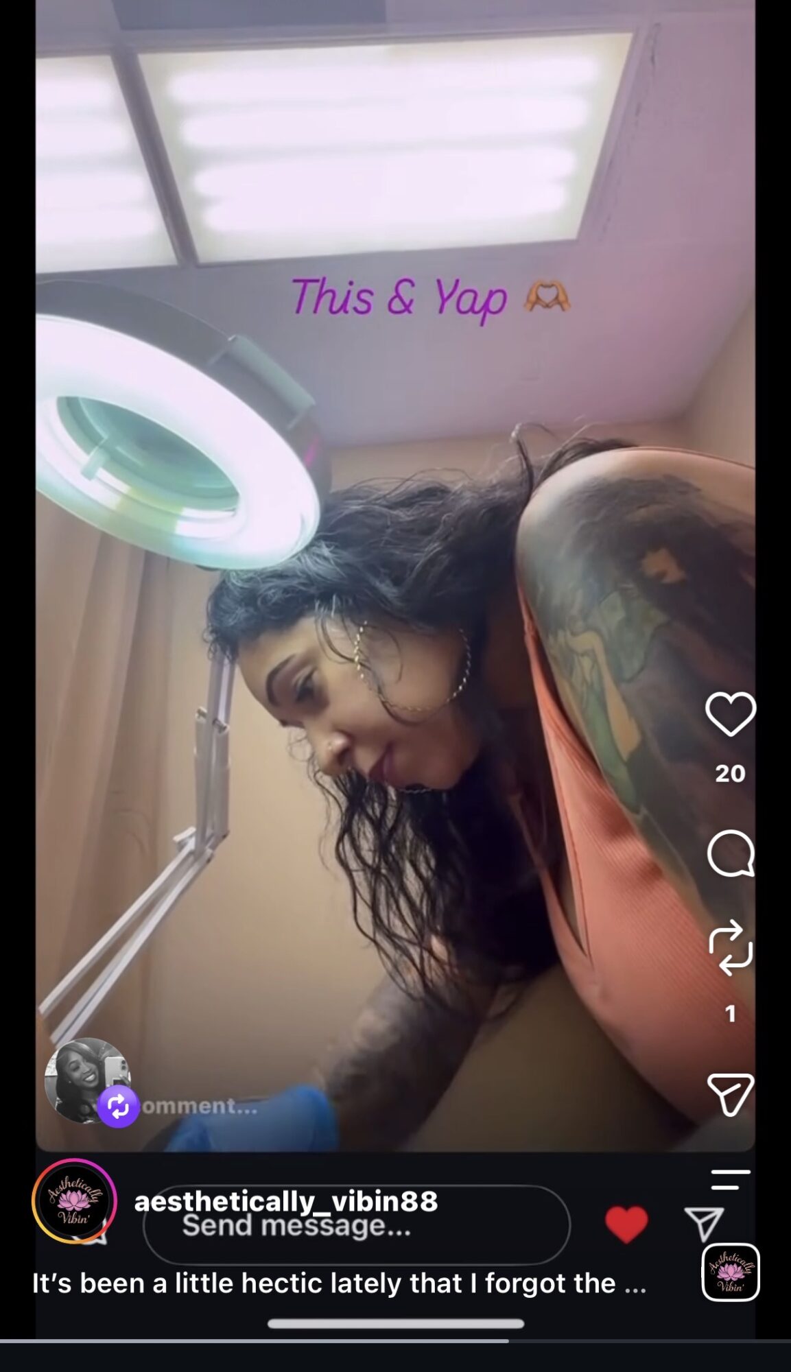 Woman with curly hair and tattoos receiving dental treatment under bright light.