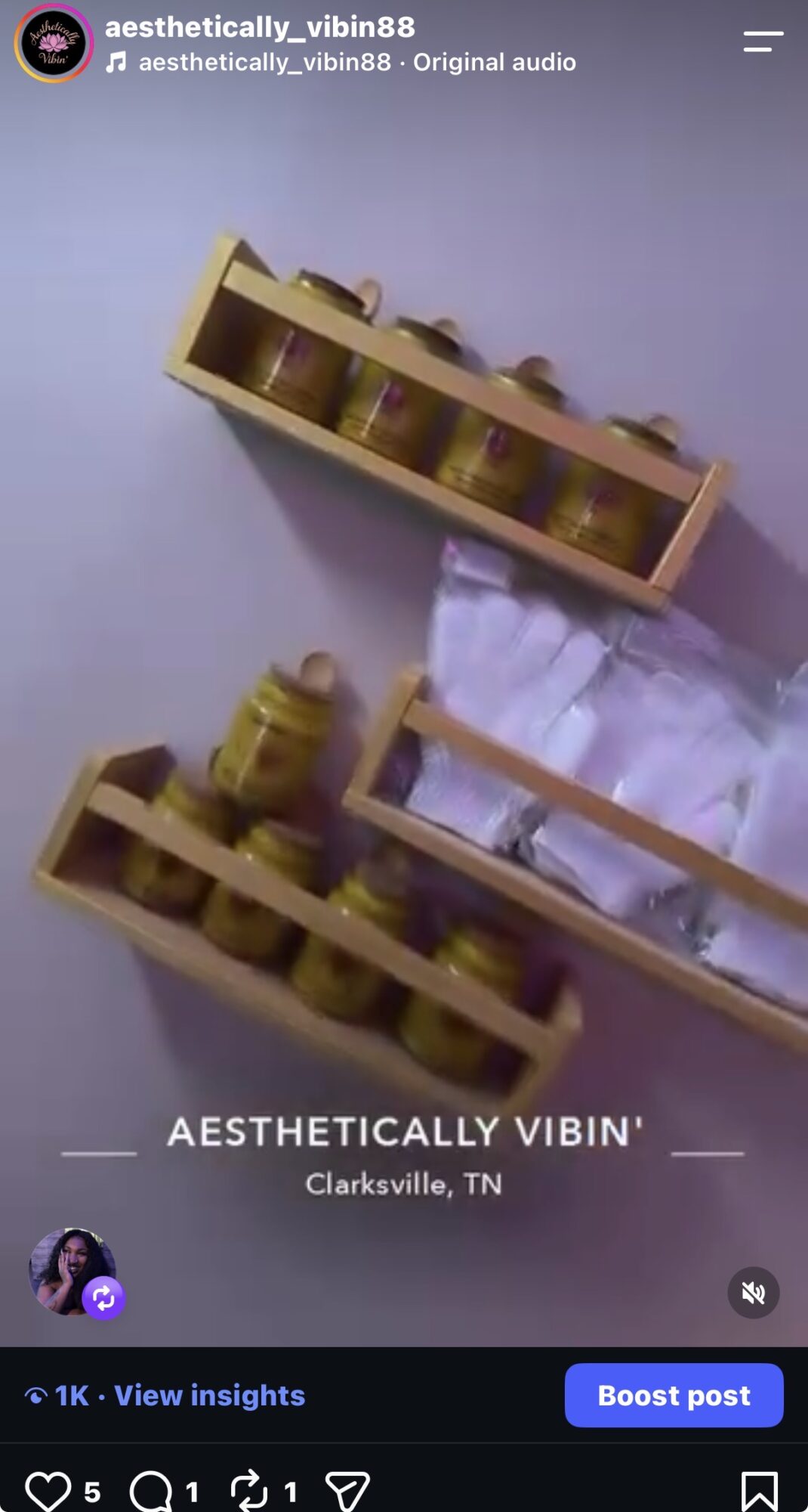 Three wooden shelves mounted on a purple wall, holding various small objects and containers, with a bed partially visible.