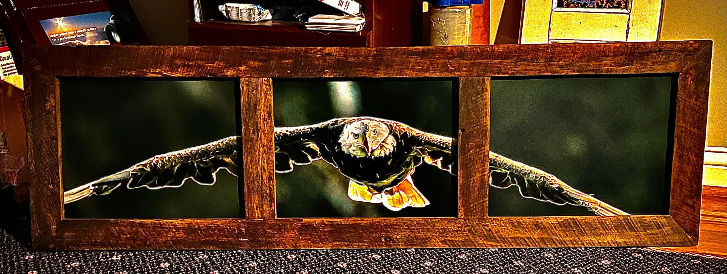 Three-panel wooden picture frame with a photograph of an eagle in flight, displayed on a shelf.