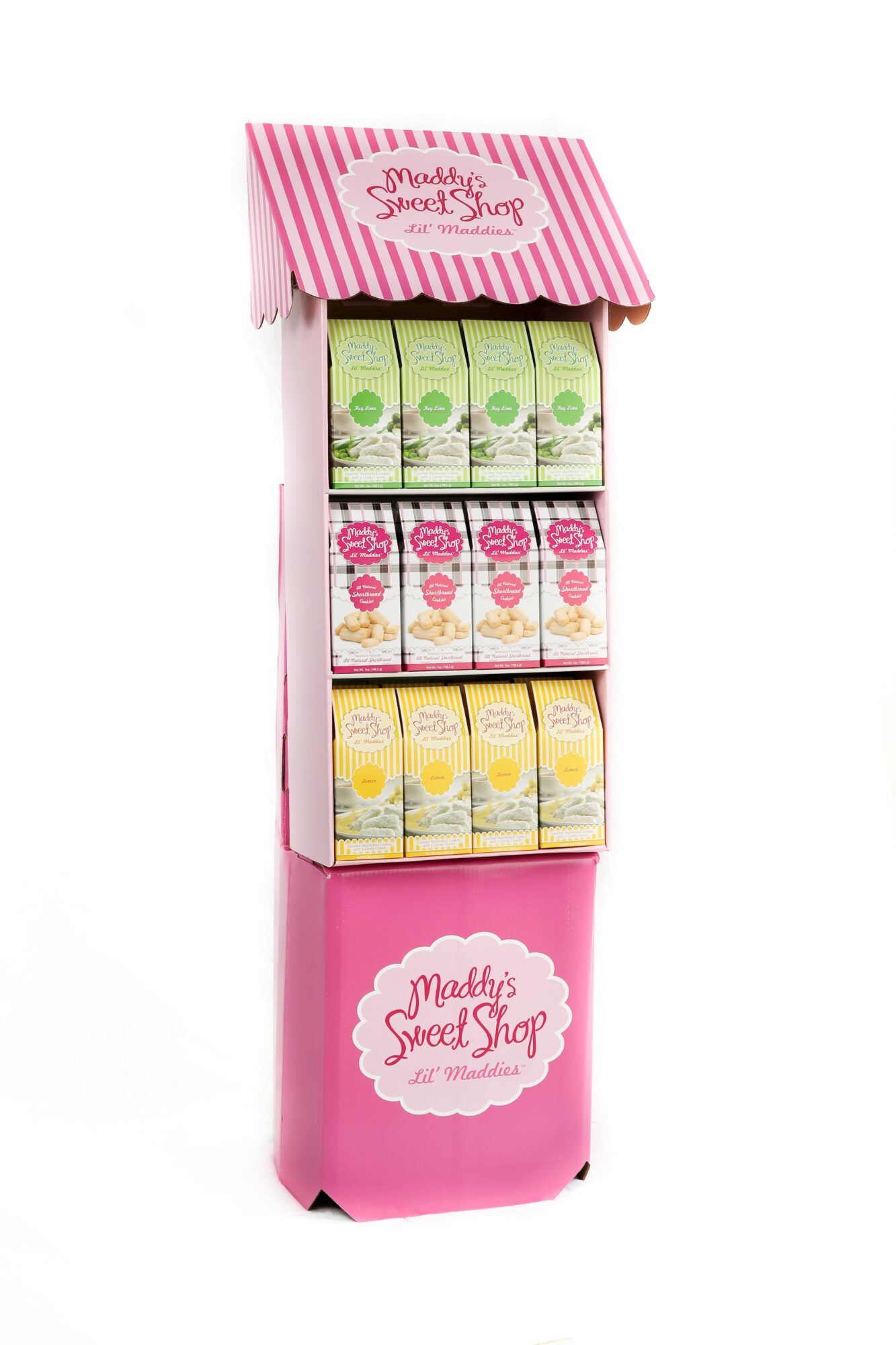 Pink display stand with three shelves of colorful juice boxes, labeled 'Maddy's Sweet Shop,' with a pink striped canopy on top.