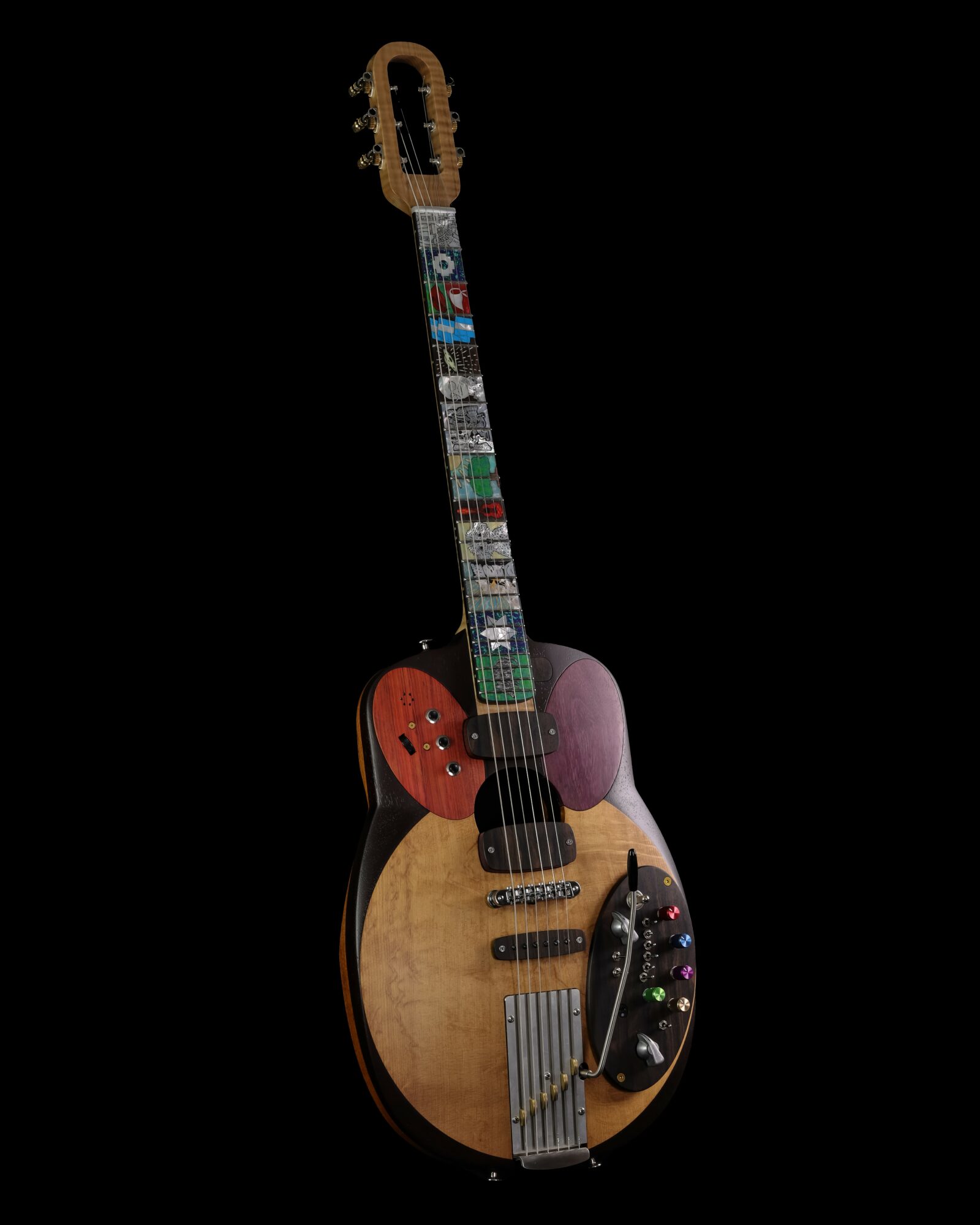 Guitar with a wooden body, colorful decorations, and a black pickguard, set against a black background.