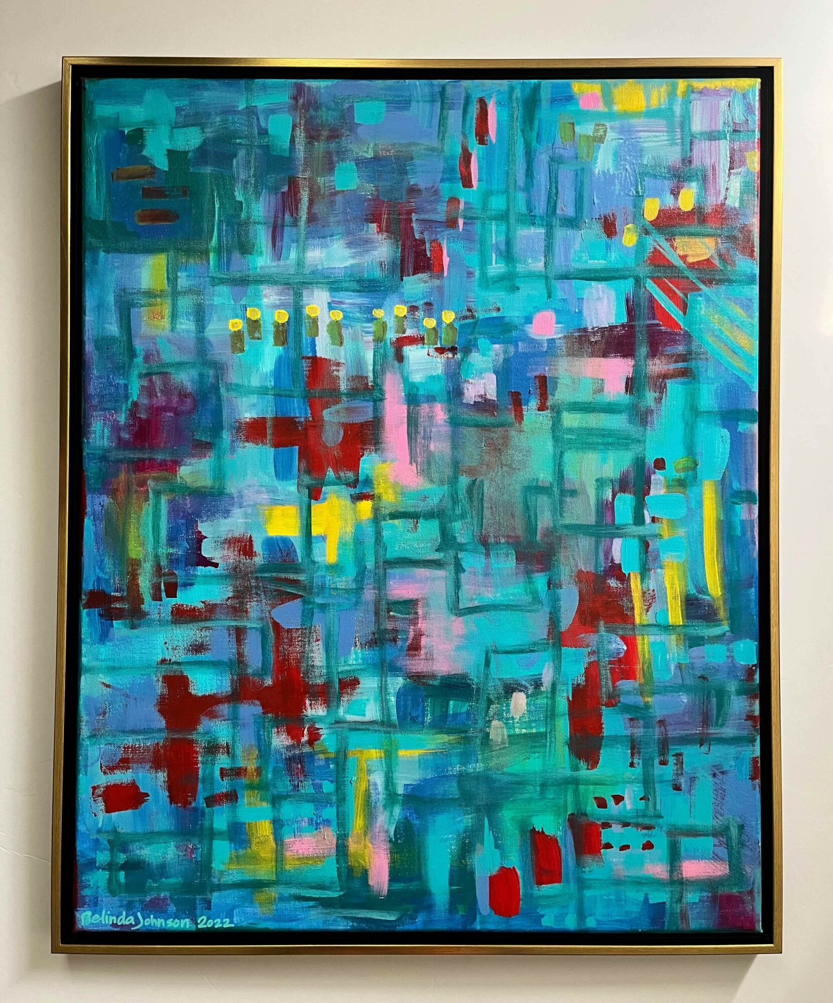 Abstract painting with blue, red, yellow, and pink geometric shapes and brushstrokes, framed in black.