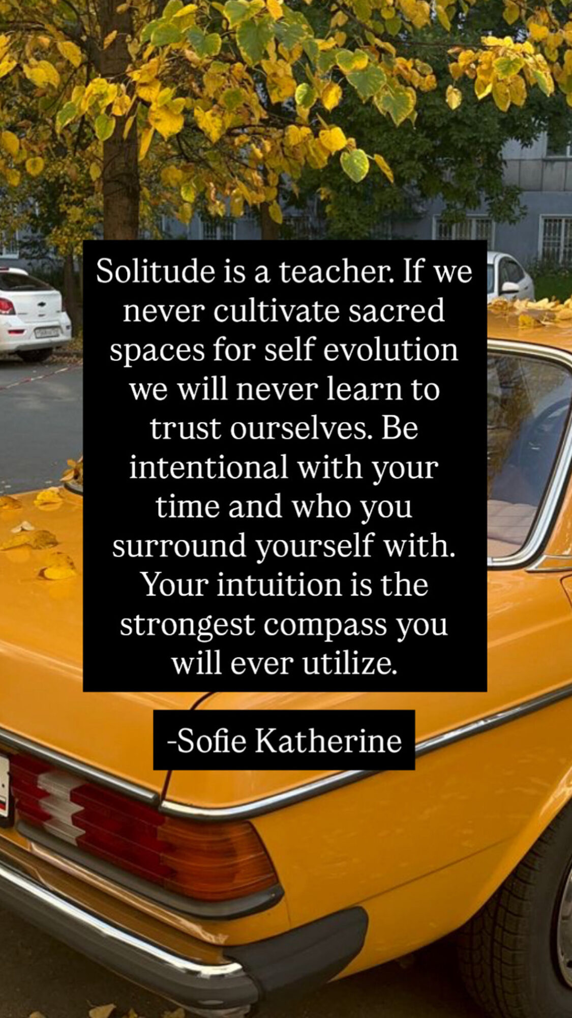 A yellow car parked outdoors with a tree and building in the background. Overlaid text quotes about solitude and self-trust.