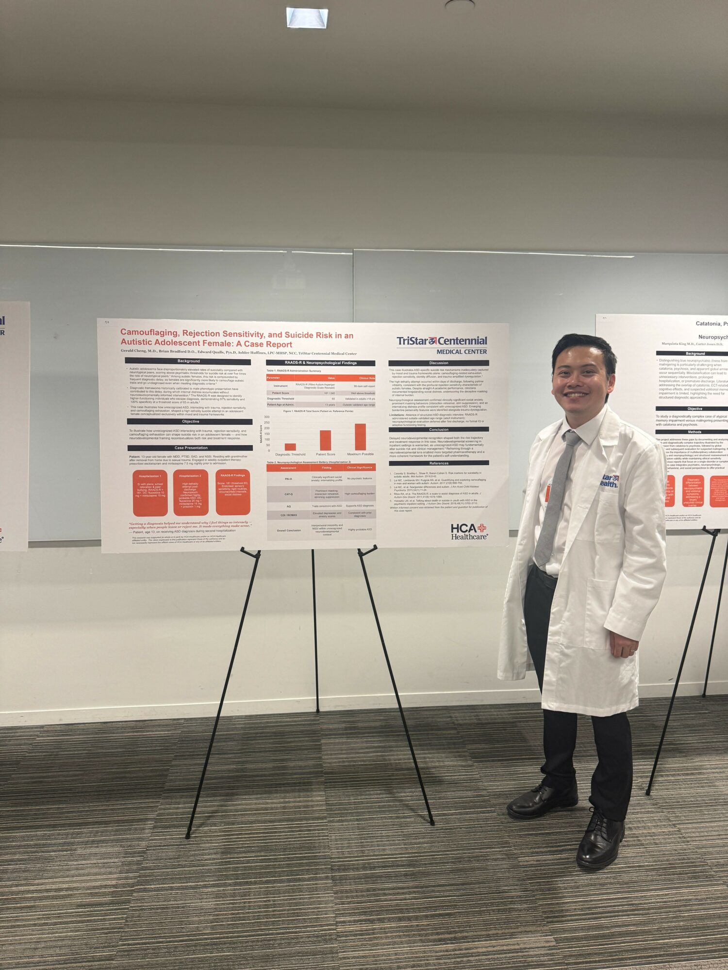 Person in a white lab coat standing next to a research poster on a wall, in an indoor setting.