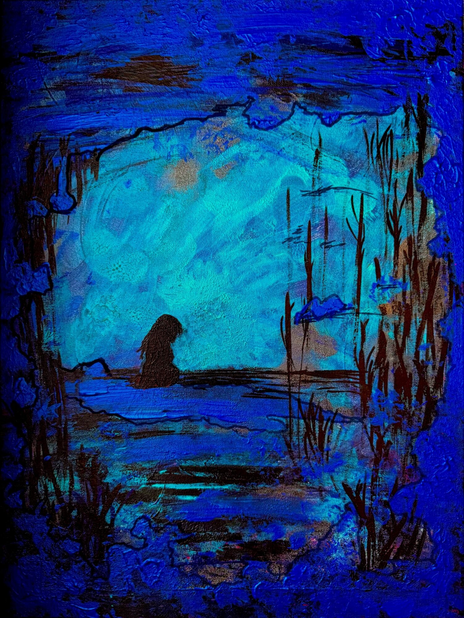 A silhouette of a person sitting near water with a blue sky and trees in the background.